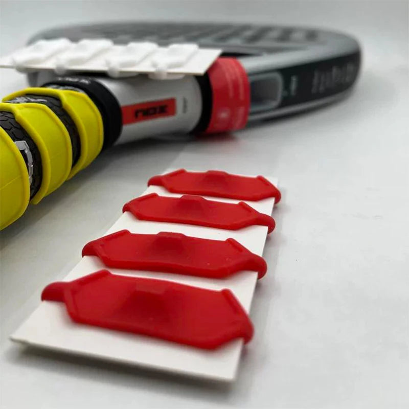 Close-up of Vexo padel racket handle with yellow grip and red vibration dampeners