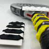Close-up of a Vexo tennis racket handle with yellow grip rings and black accessories.