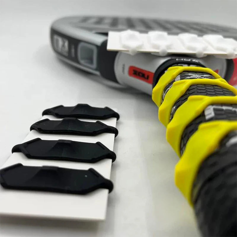 Close-up of a Vexo tennis racket handle with yellow grip rings and black accessories.